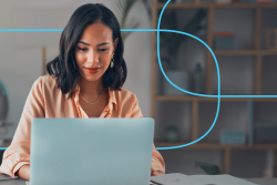 professional woman reviewing her CV on a laptop in a modern home office – concept of optimizing a medical CV for ATS (applicant tracking systems)